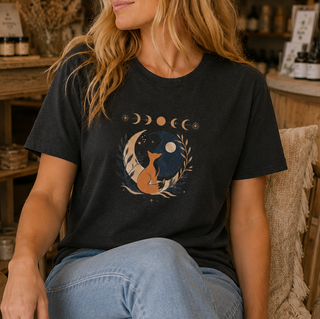 Folded Black Heather Celestial Fox tee with a fox yin-yang, moon phases and botanicals