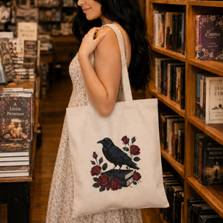 Close-up of raven on stacked books with red roses print on Natural canvas tote