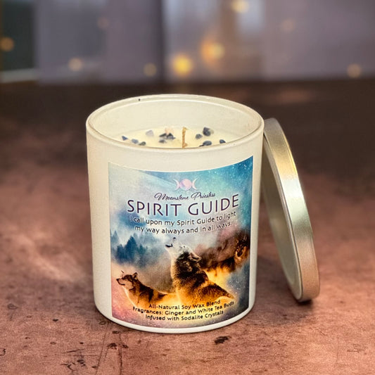Candle with 'Spirit Guide' label featuring wolves on a wooden surface