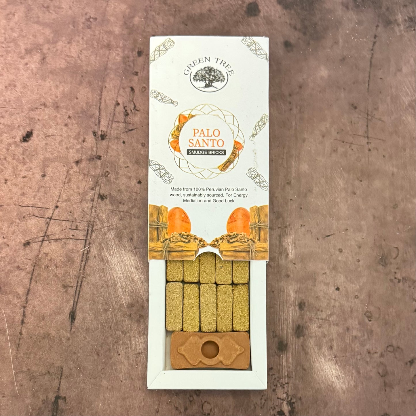 Palo Santo incense sticks packaging on a textured surface