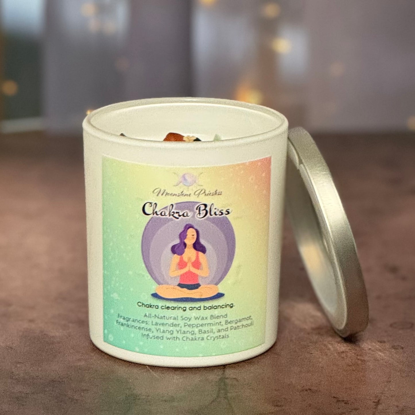Candle with a label titled 'Chakra Bliss' on a wooden surface.