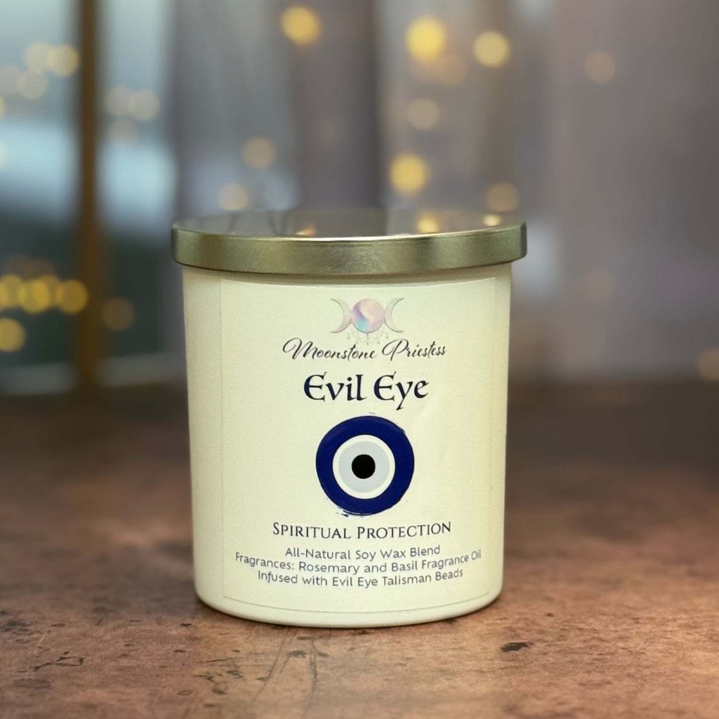 Candle labeled 'Evil Eye' with a blue eye symbol on a wooden surface.