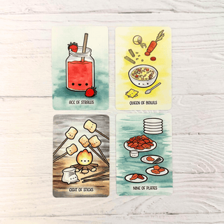 Four illustrated food-themed cards arranged in a 2x2 grid on a white wood background. The cards read 'ACC OF STRAWLUS', 'ORION OF BOWLS', 'CRAFT OF STICKS', and 'NINE OF PLATES', each with a cute cartoon drawing above the text.