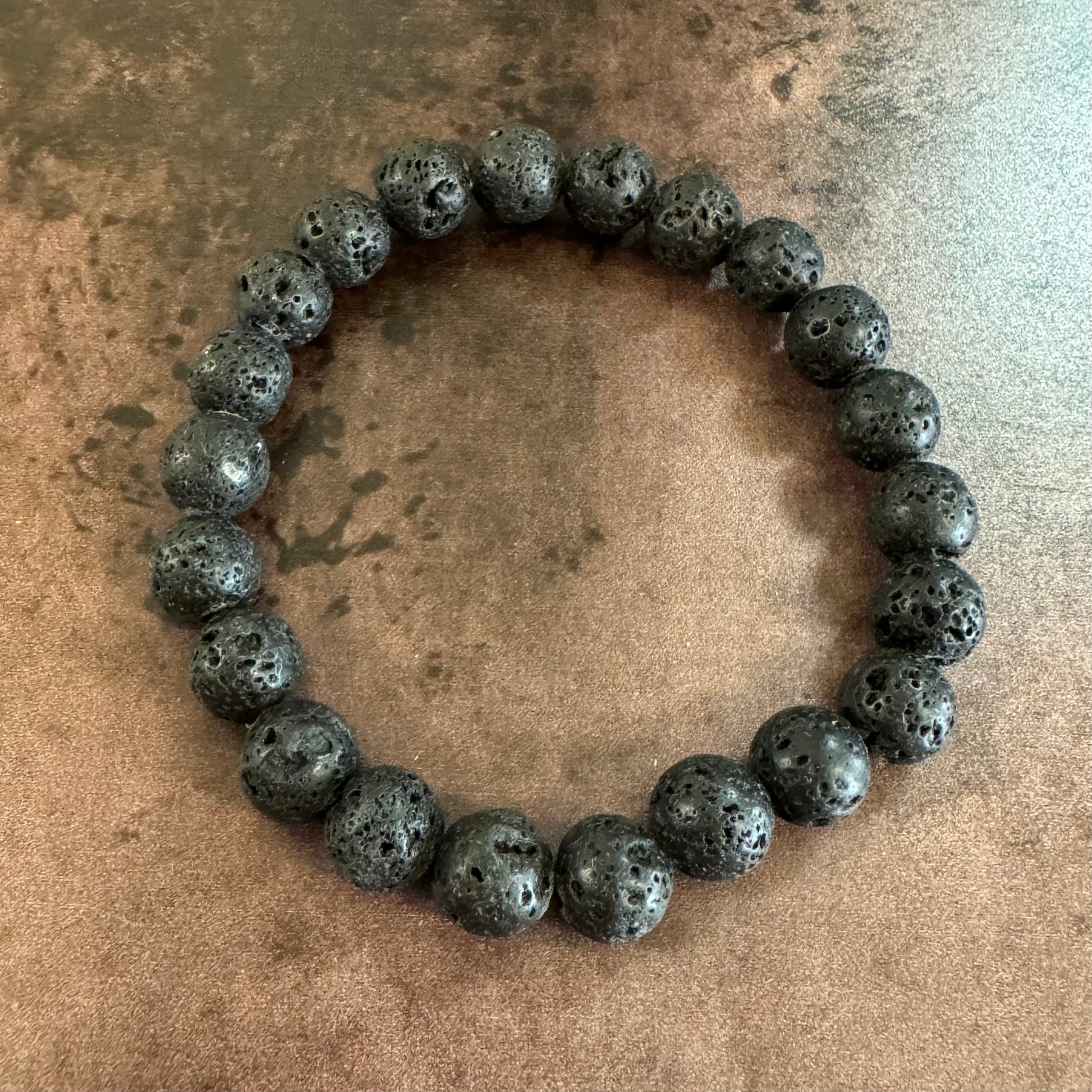 Lava stone bracelet on a textured surface