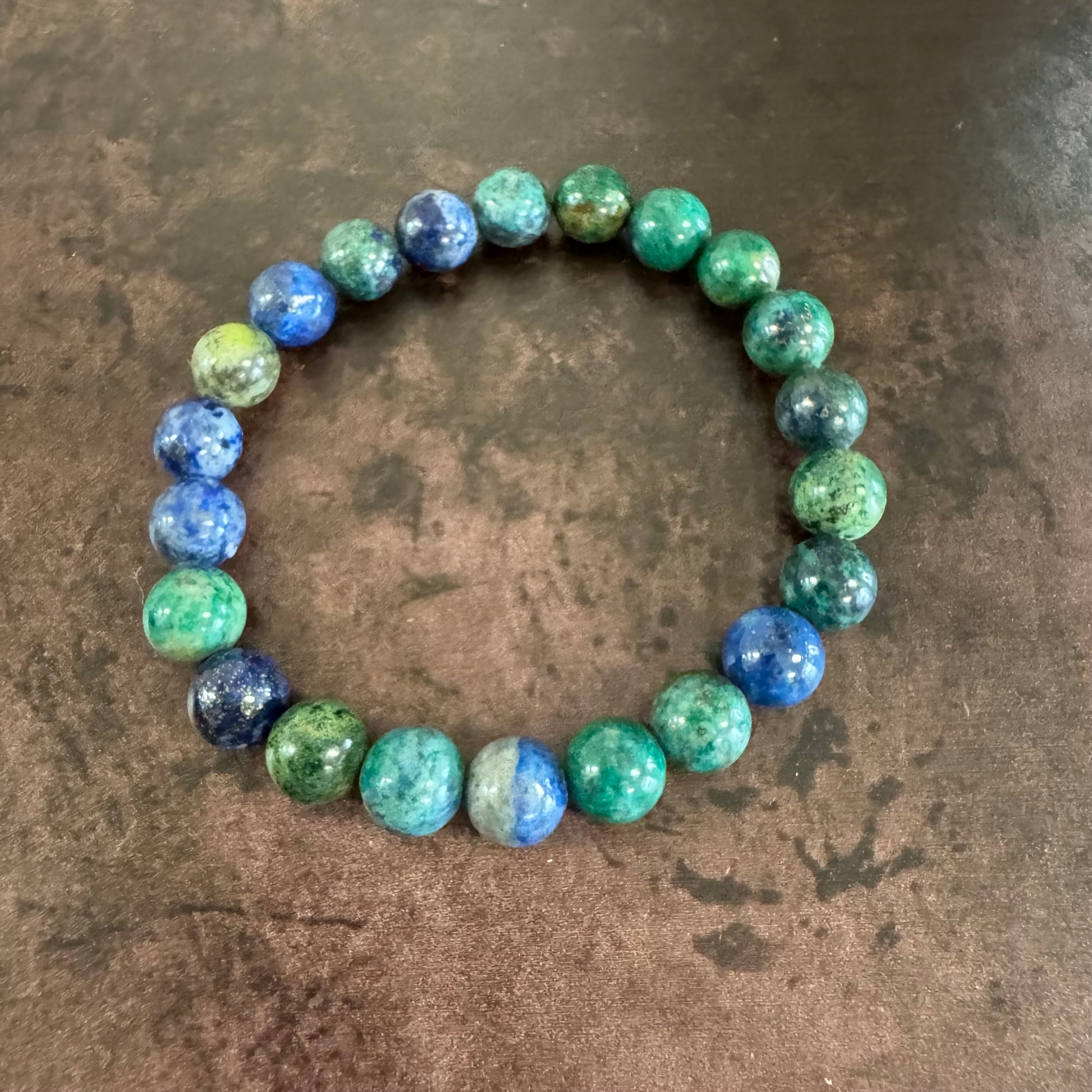 Multicolored beaded bracelet on a textured brown surface