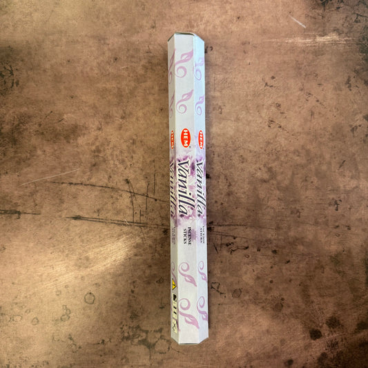 Vanilla-scented incense stick box on a textured brown surface