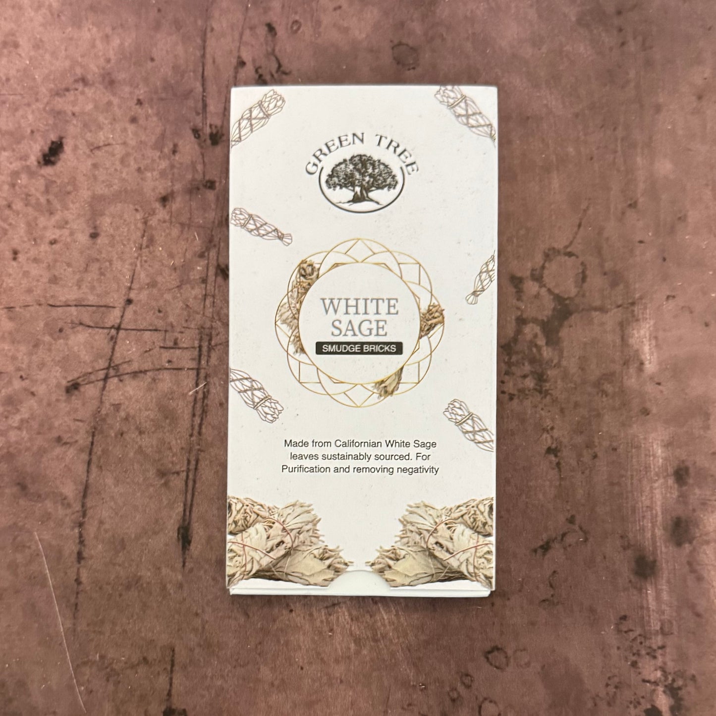 Green Tree White Sage incense packaging on a textured brown background