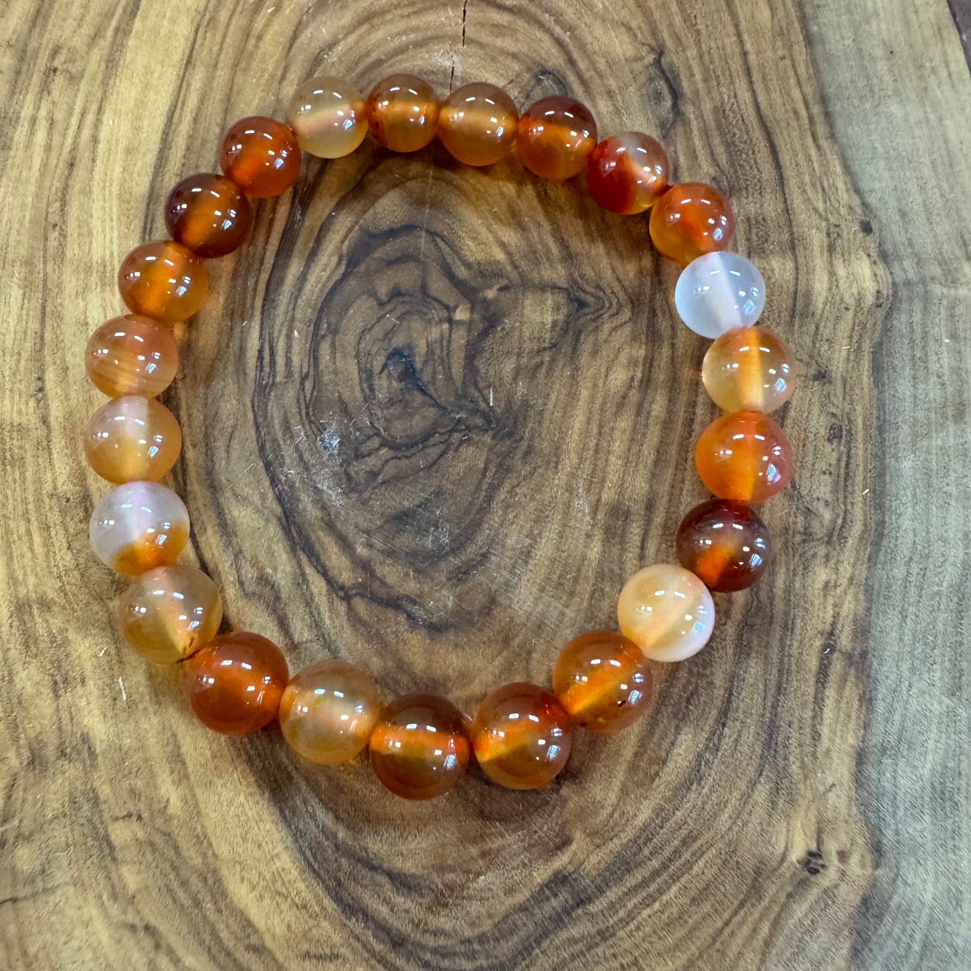 Beaded bracelet with brown and white beads on a wooden surface
