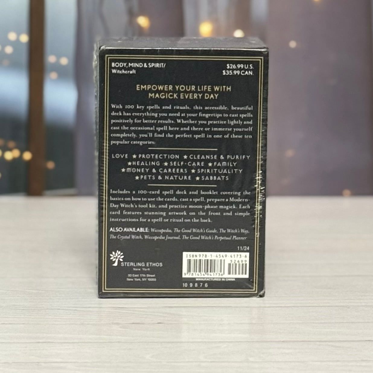 Back of a card deck packaging with text and branding on a neutral background
