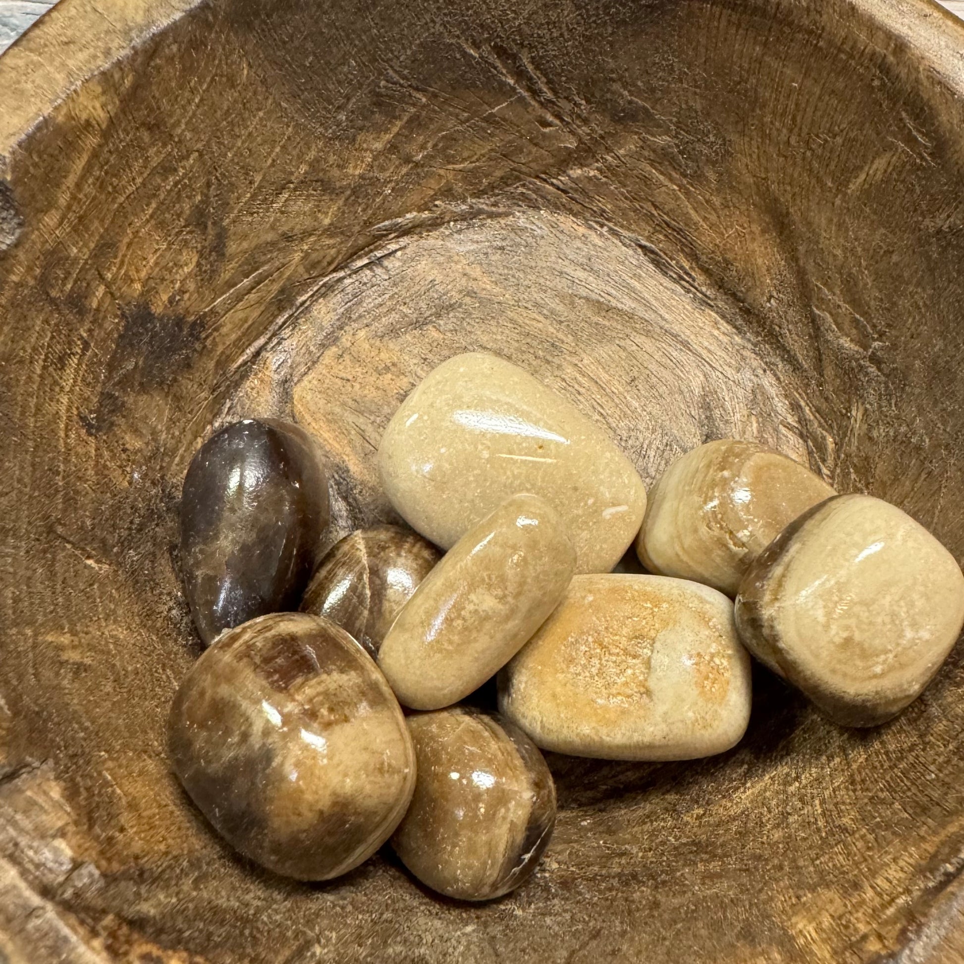 Wooden bowl with smooth stones inside
