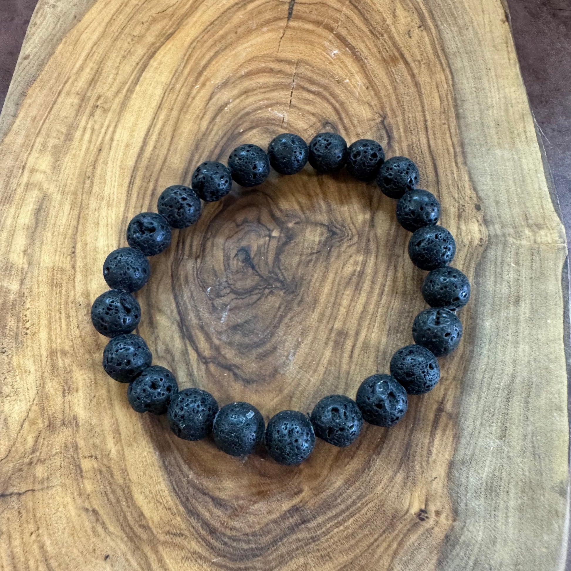 Black beaded bracelet on a wooden surface