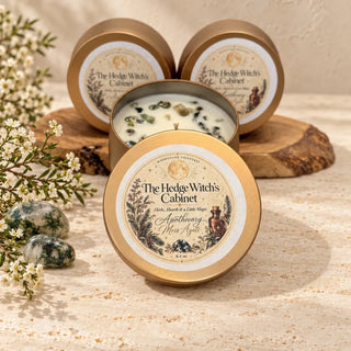 Moss agate crystal chips set in the wax of The Hedge Witch's Cabinet Apothecary candle