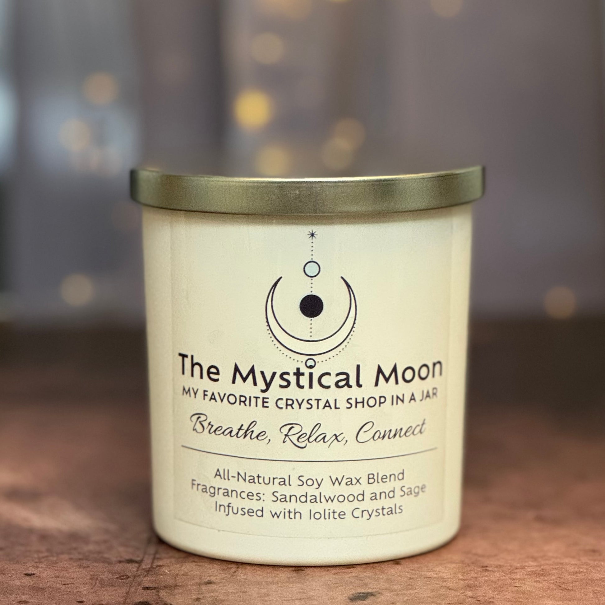 Candle with 'The Mystical Moon' label on a wooden surface