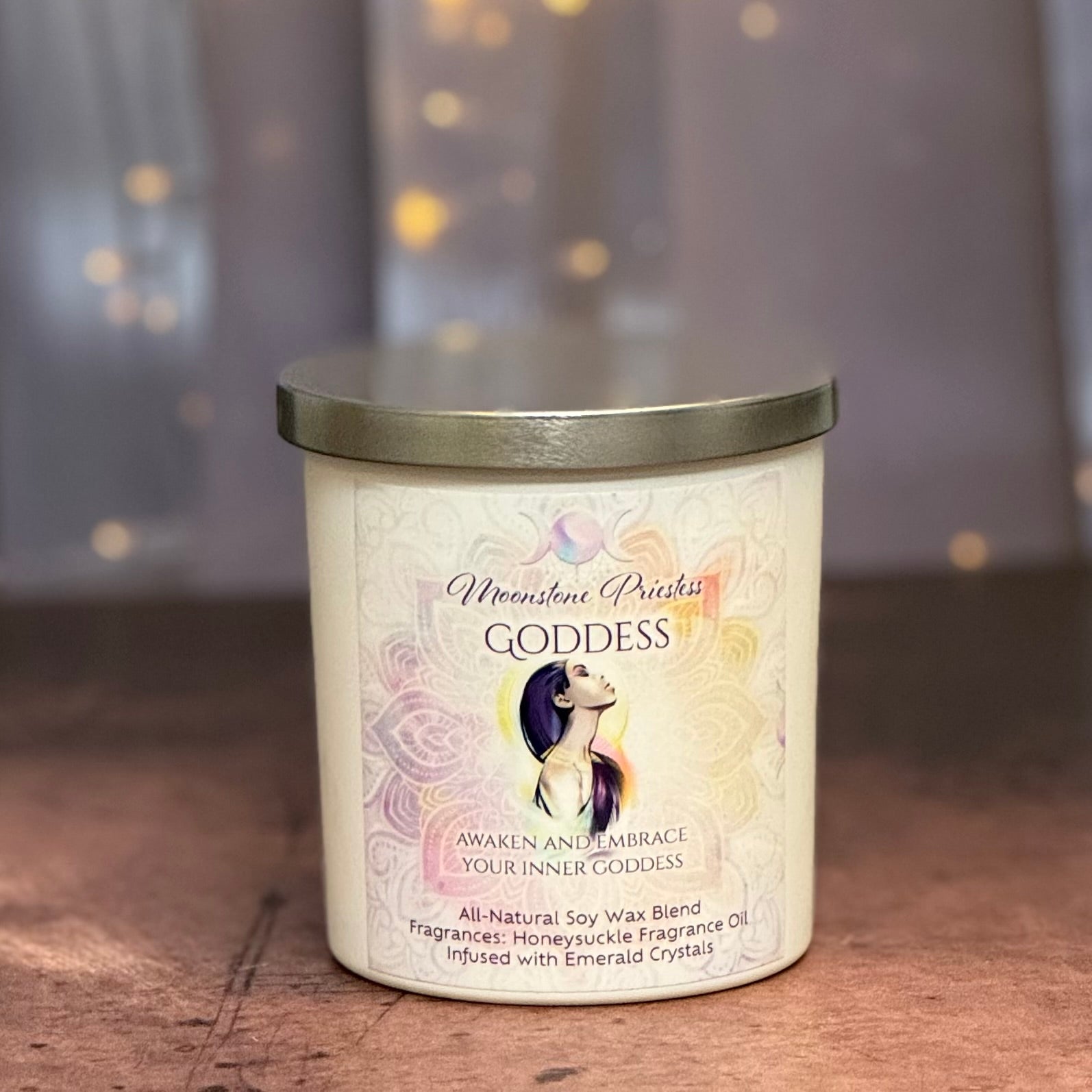 Candle labeled 'Goddess' with a decorative design on a wooden surface.