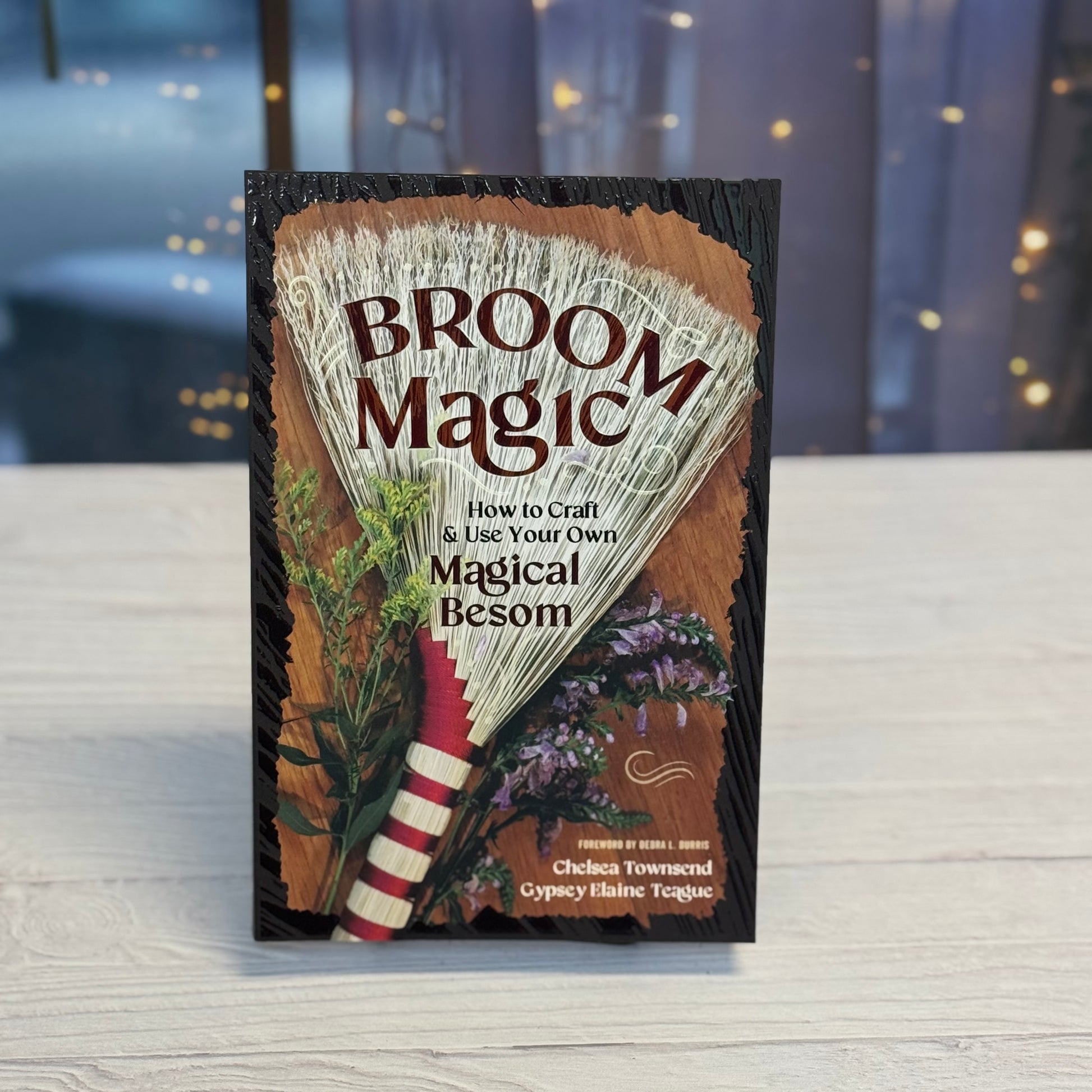 Book titled 'Broom Magic' on a wooden surface with a blurred background