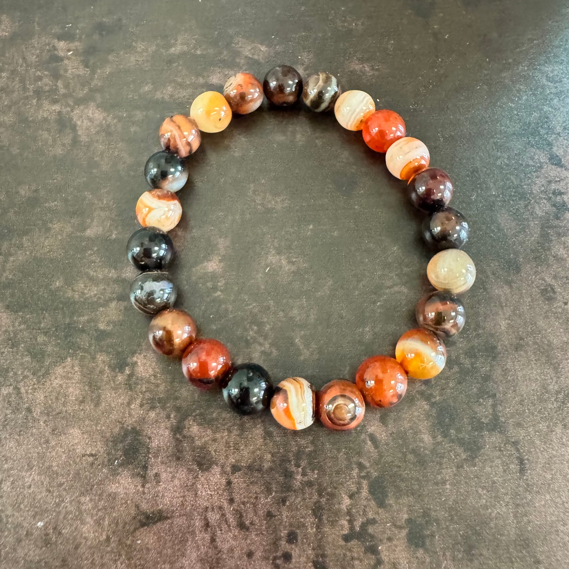 Multicolored beaded bracelet on a textured surface