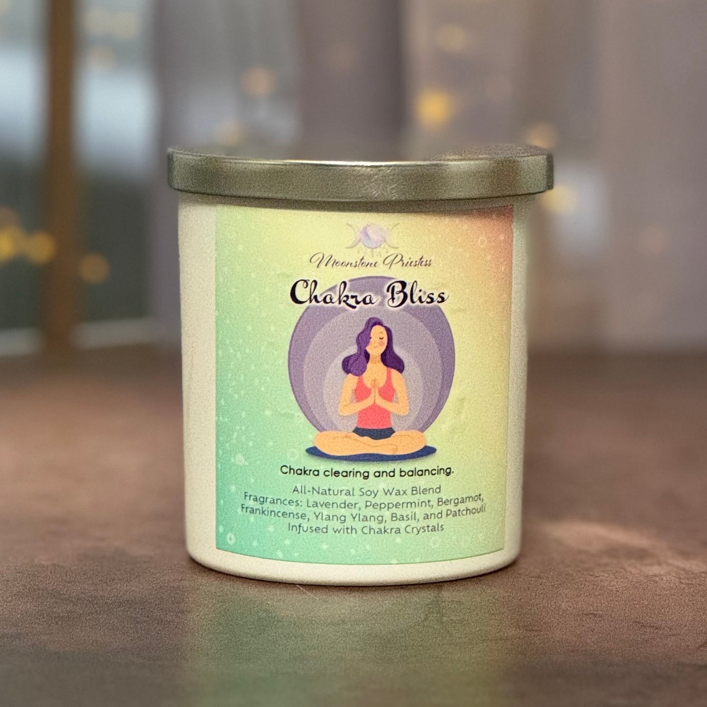 Candle with 'Chakra Bless' label on a blurred background