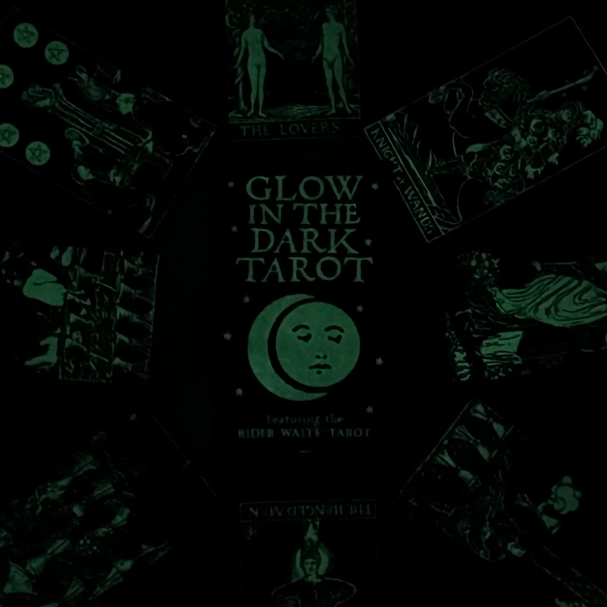 Glow-in-the-dark tarot cards with packaging on a dark background