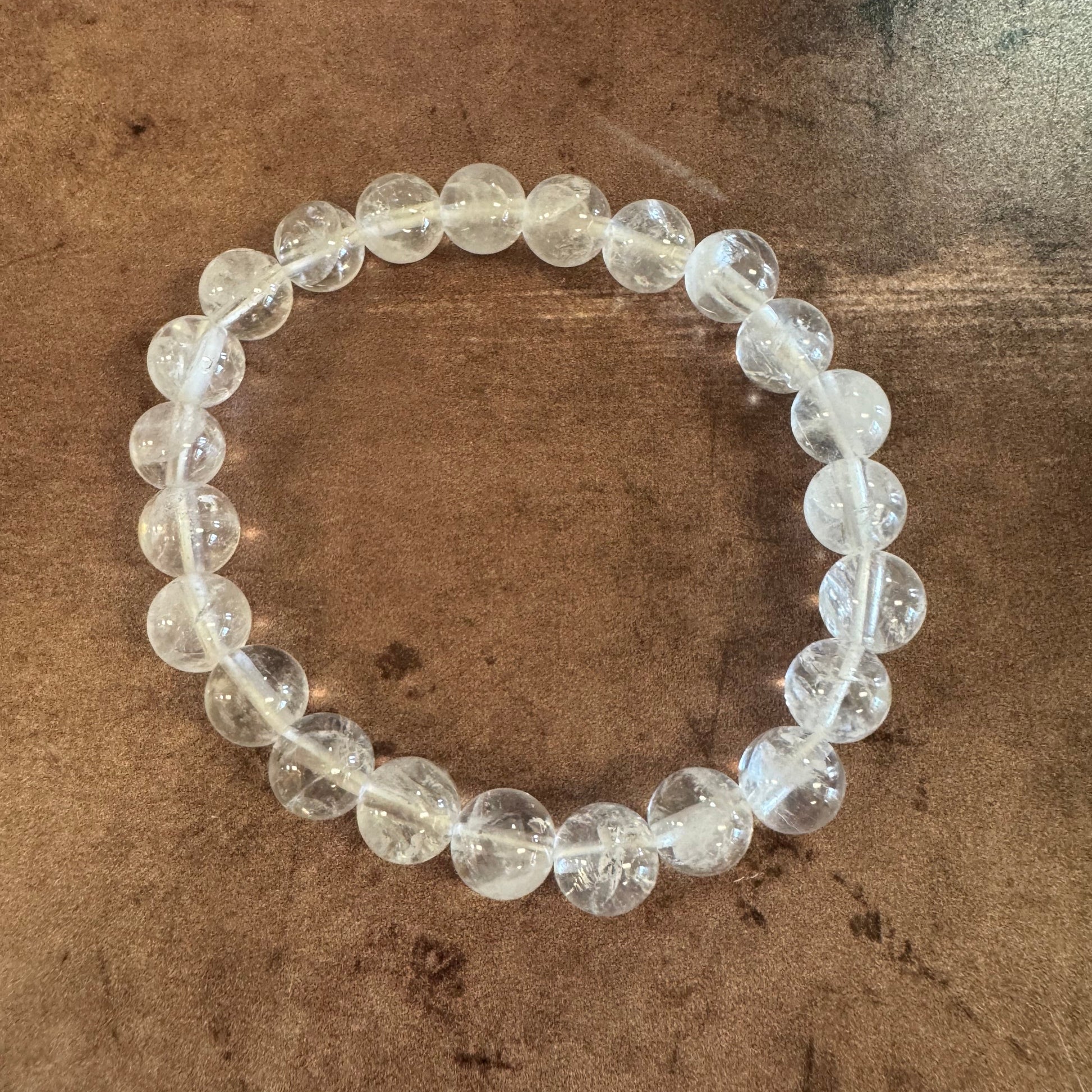 Clear beaded bracelet on a textured brown background