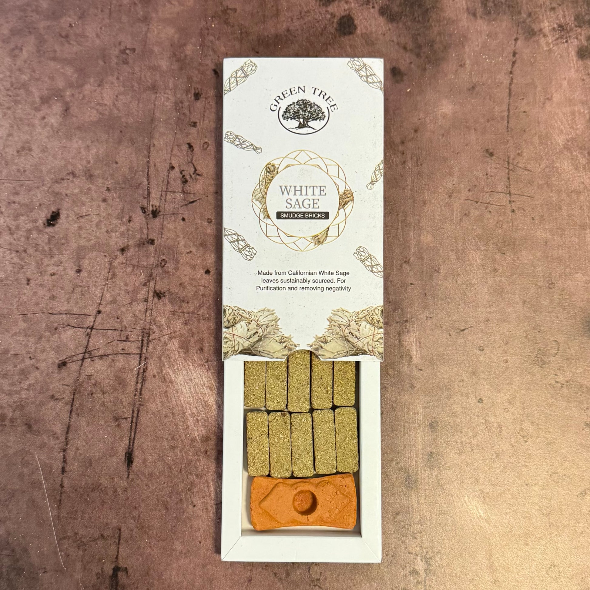 White Sage smudge stick packaging on a textured brown background