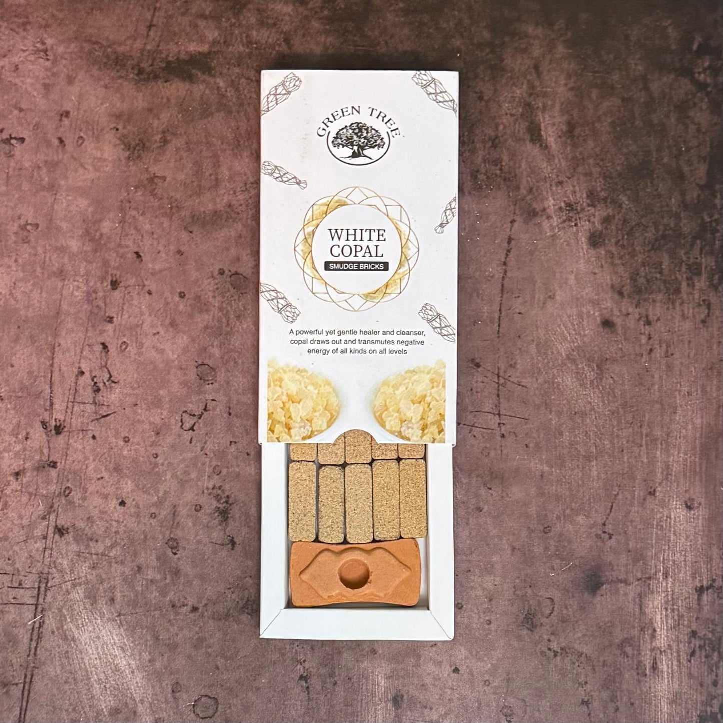 White Copal incense packaging on a textured brown background