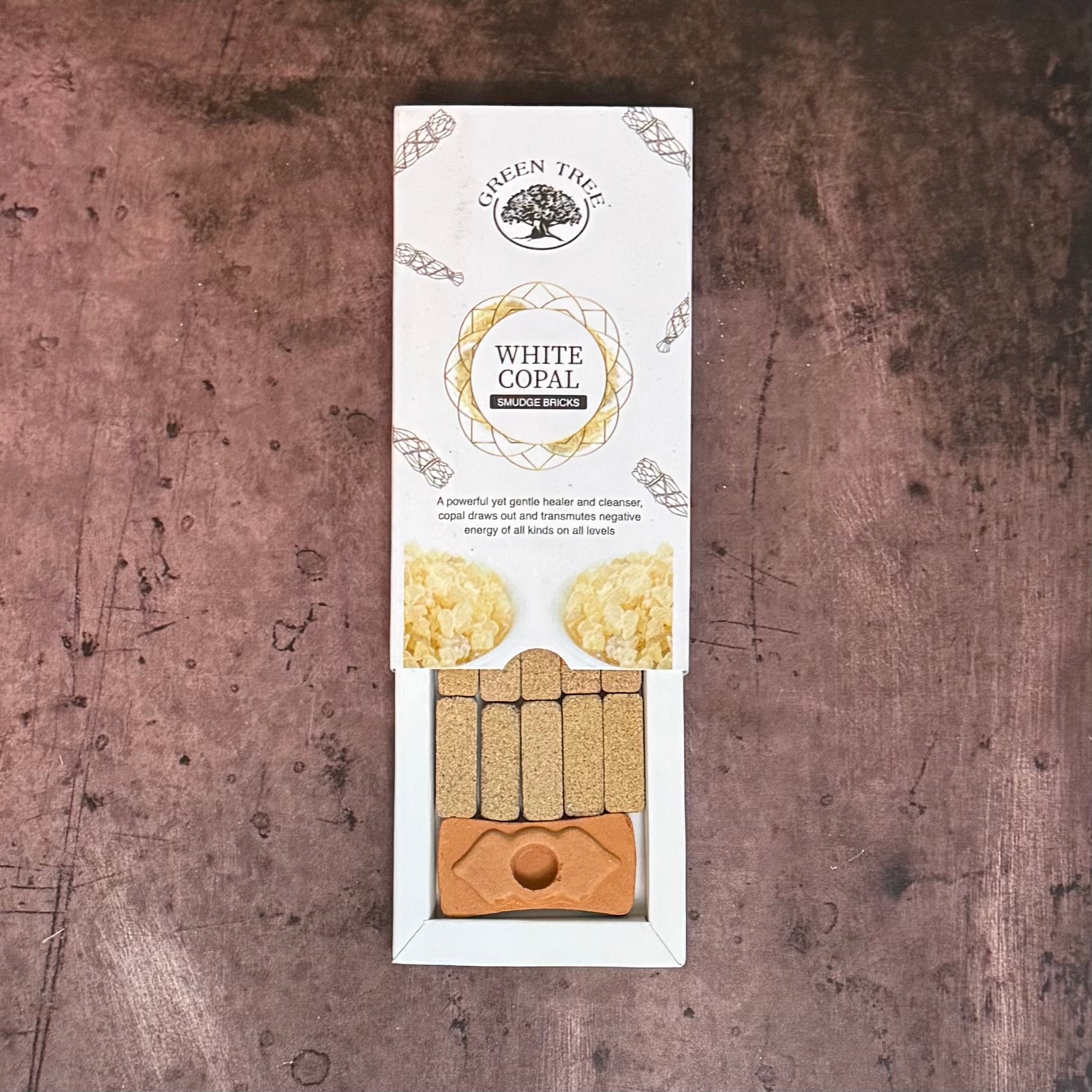 White Copal incense packaging on a textured brown background