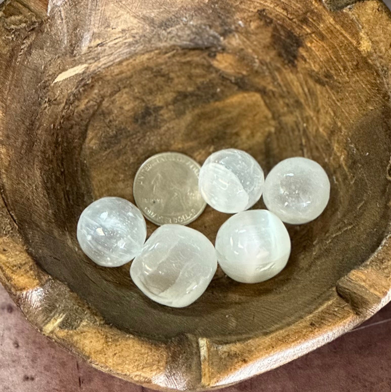 Five selenite crystals in a wooden bowl