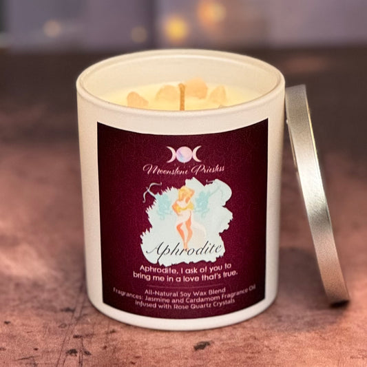 Candle in a white container with a label featuring an illustration of a fairy and text on a wooden surface.