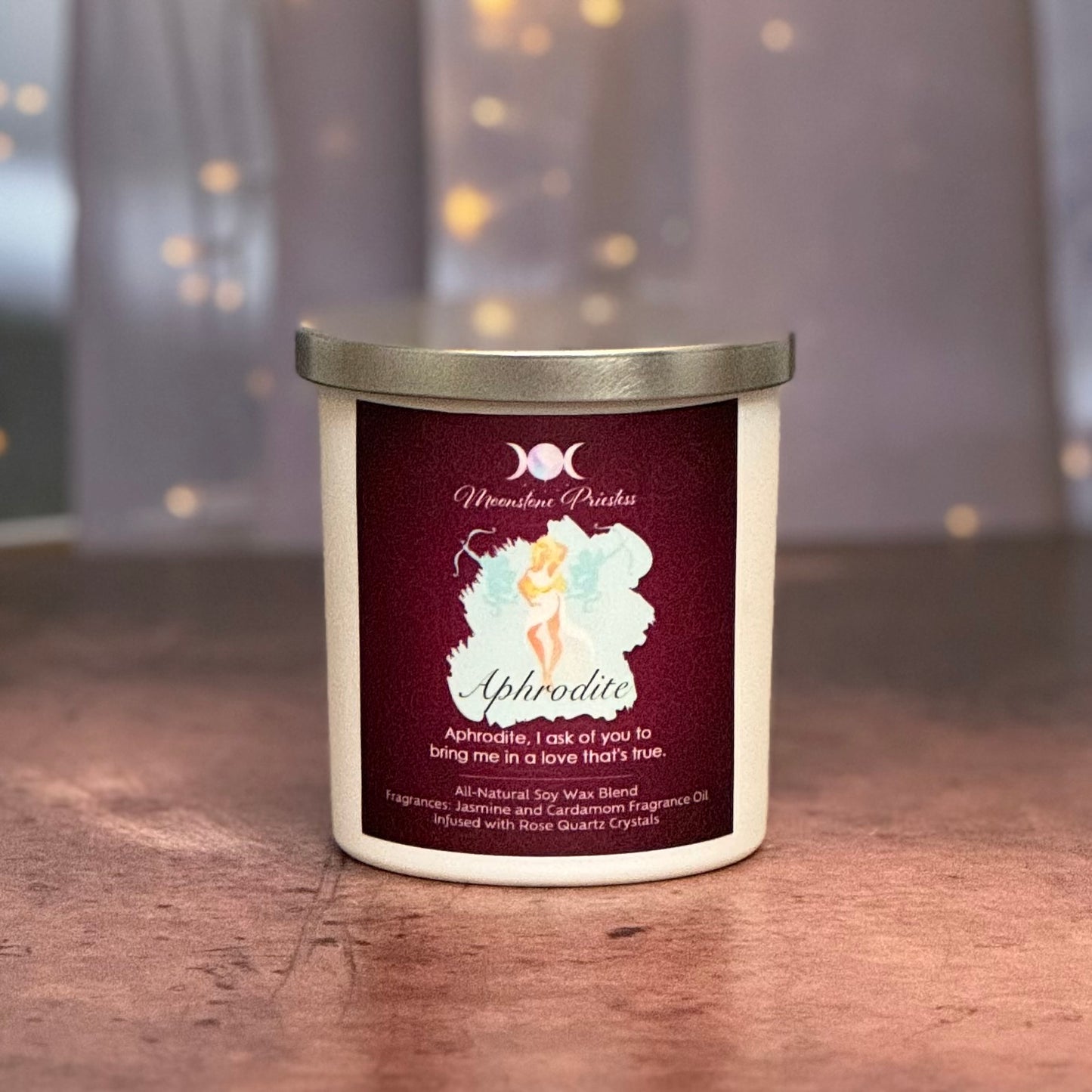 Candle with a label featuring a fairy design on a wooden surface.