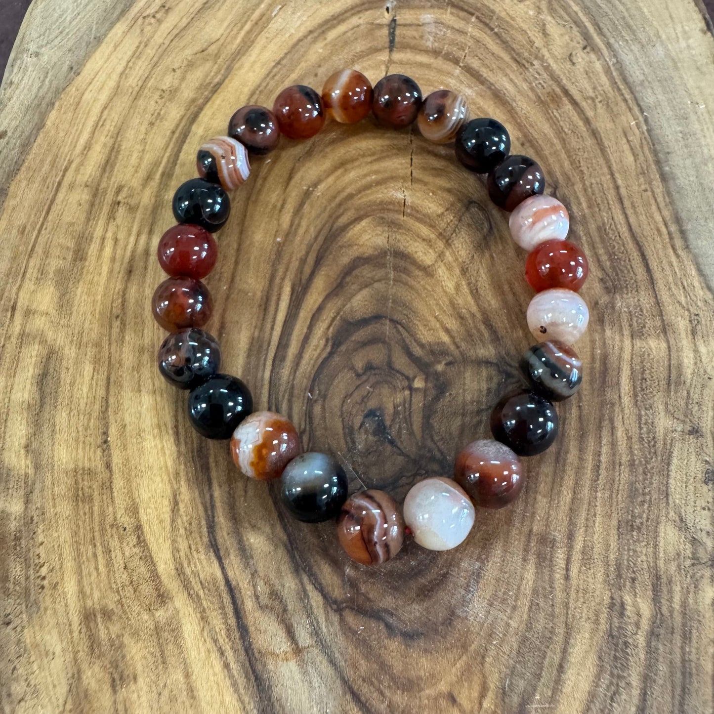 Beaded bracelet with multicolored beads on a wooden surface