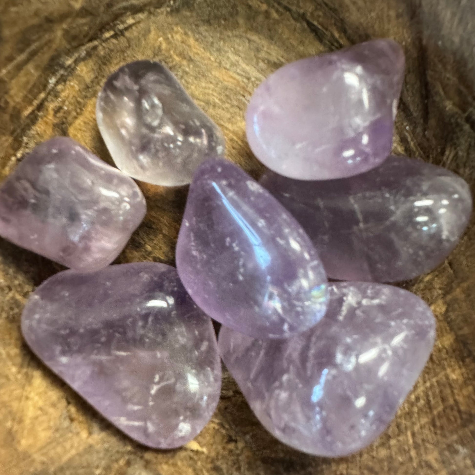 Purple crystals on a wooden surface