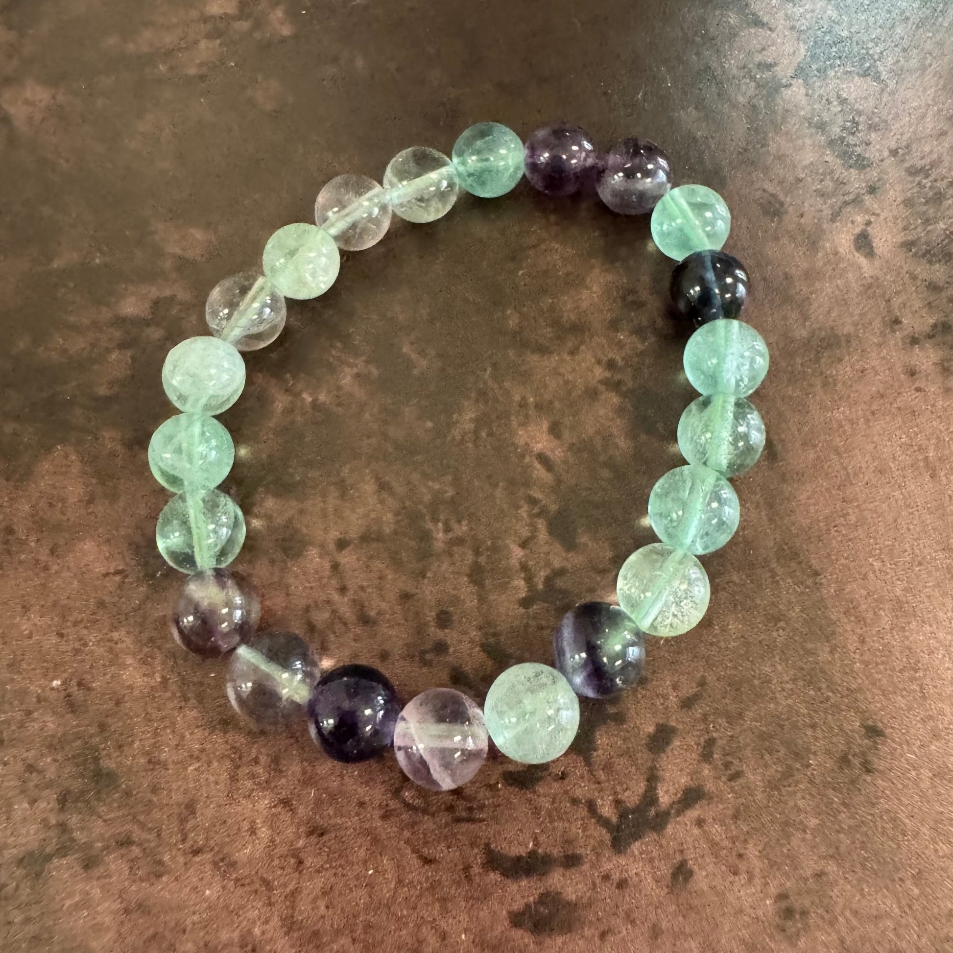 Multicolored beaded bracelet on a textured surface