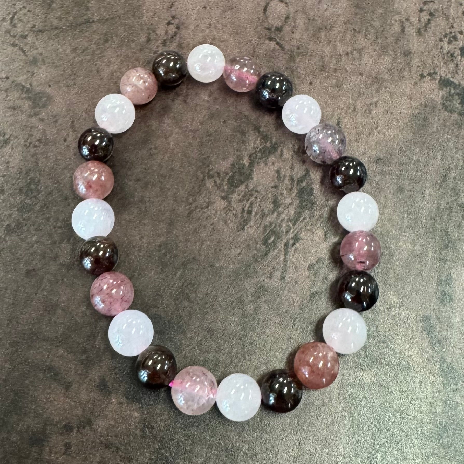 Round beaded bracelet with multicolored beads on a textured surface