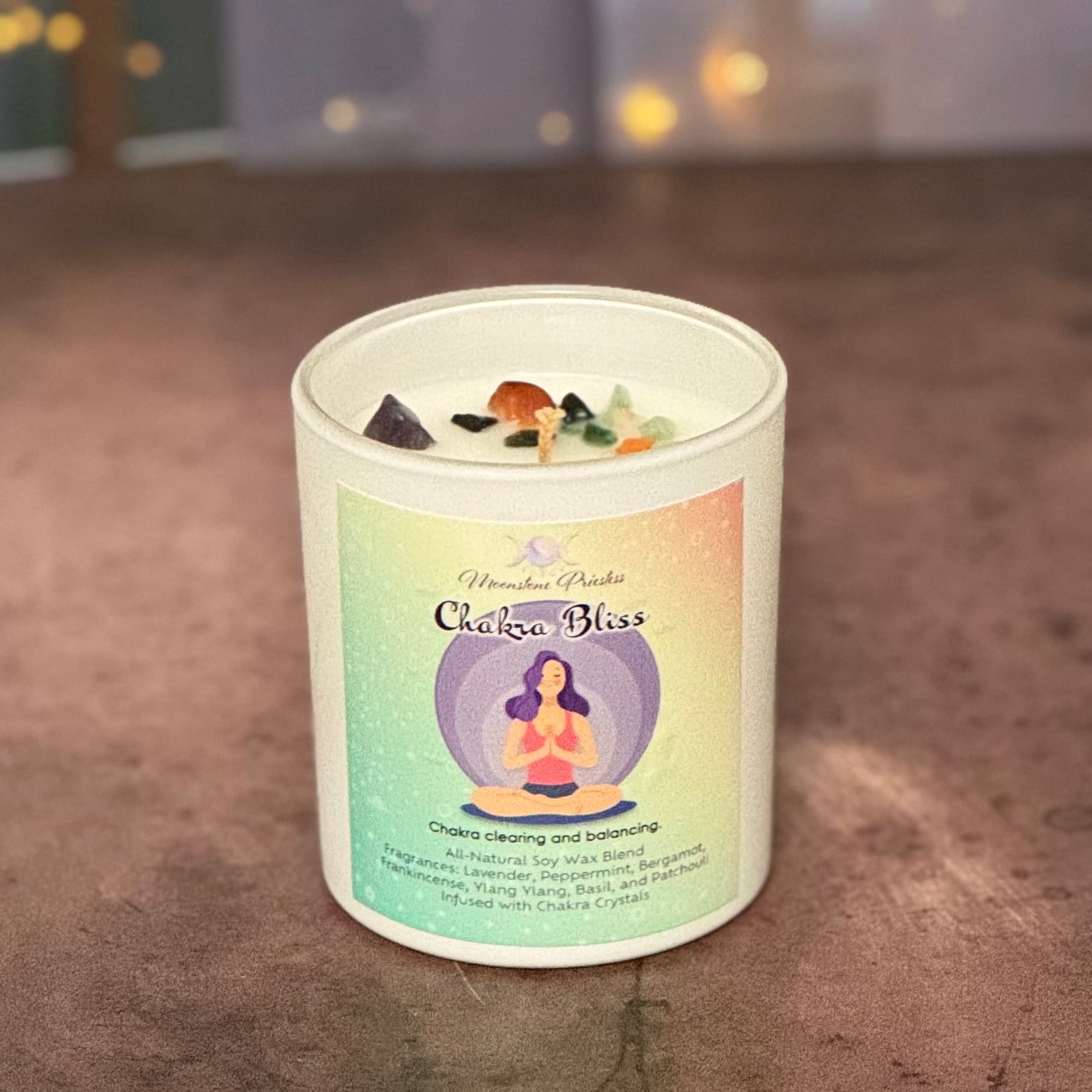Candle in a white container with a colorful label on a textured surface