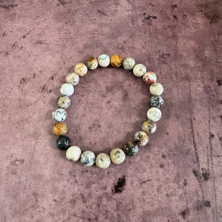 Multicolored beaded bracelet on a textured brown surface