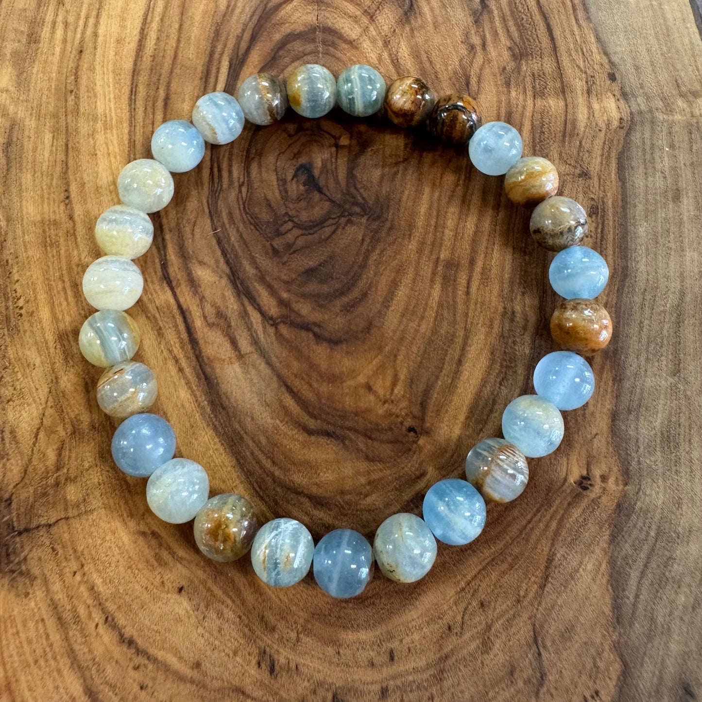 Beaded bracelet with multicolored beads on a wooden surface
