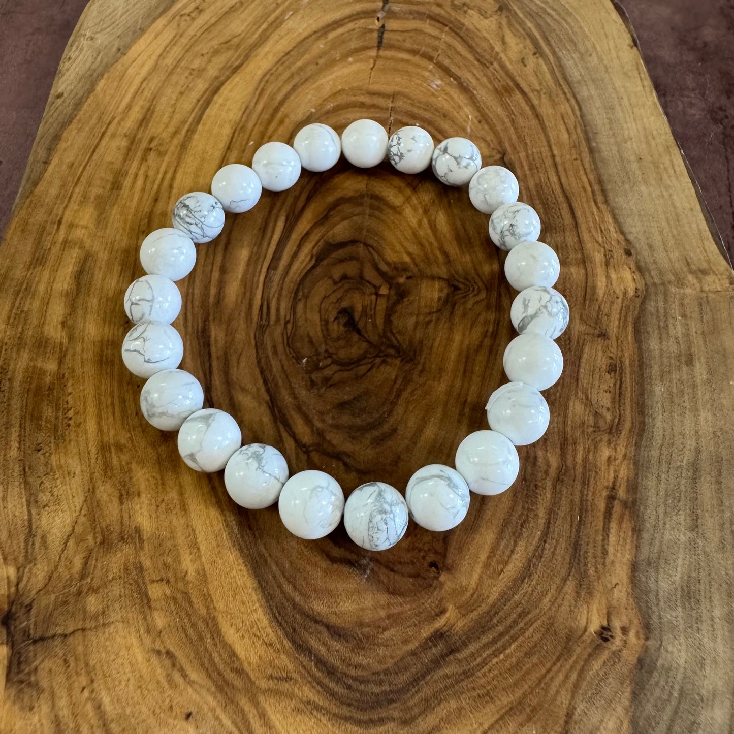 White beaded bracelet on a wooden surface