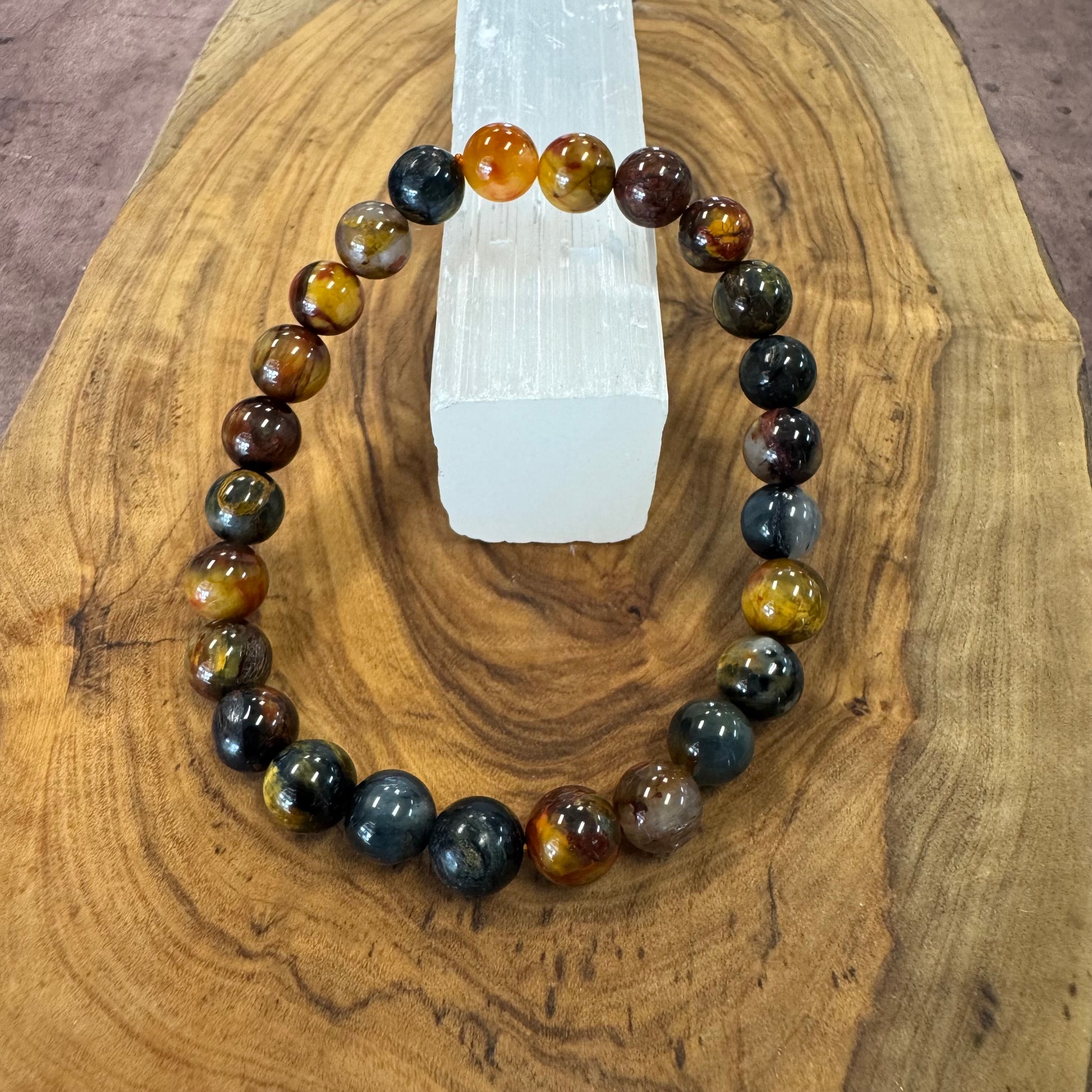 Beaded bracelet with multicolored beads on a wooden surface