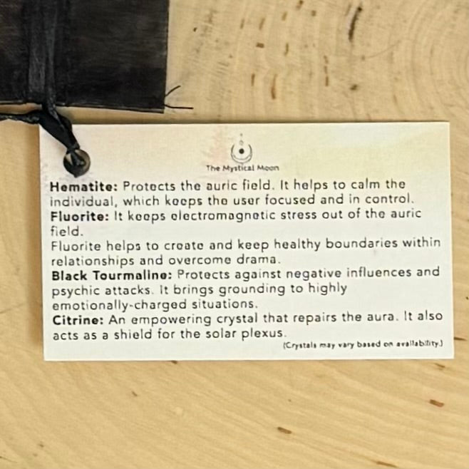 Card with crystal information on a wooden surface