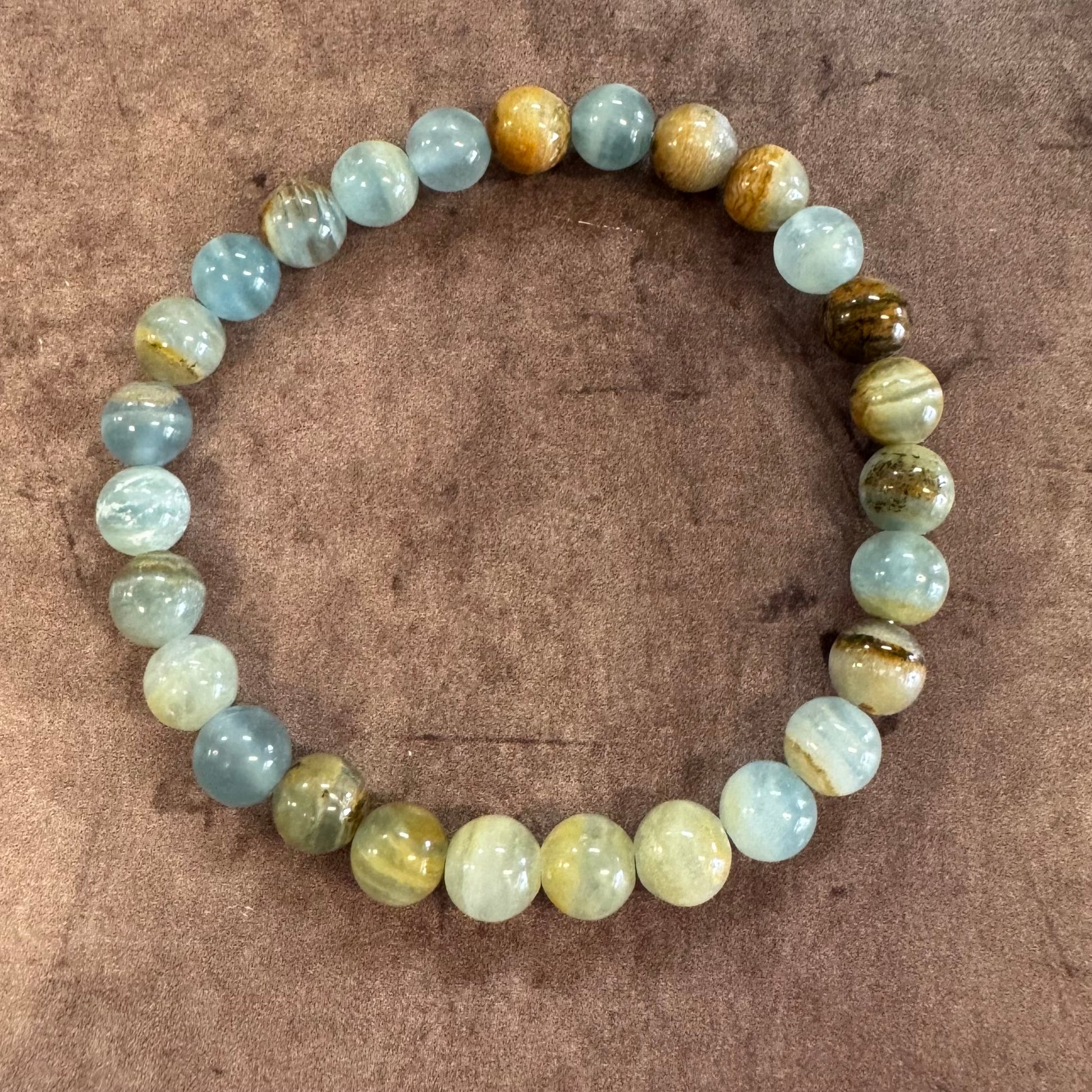 Beaded bracelet with multicolored beads on a brown background