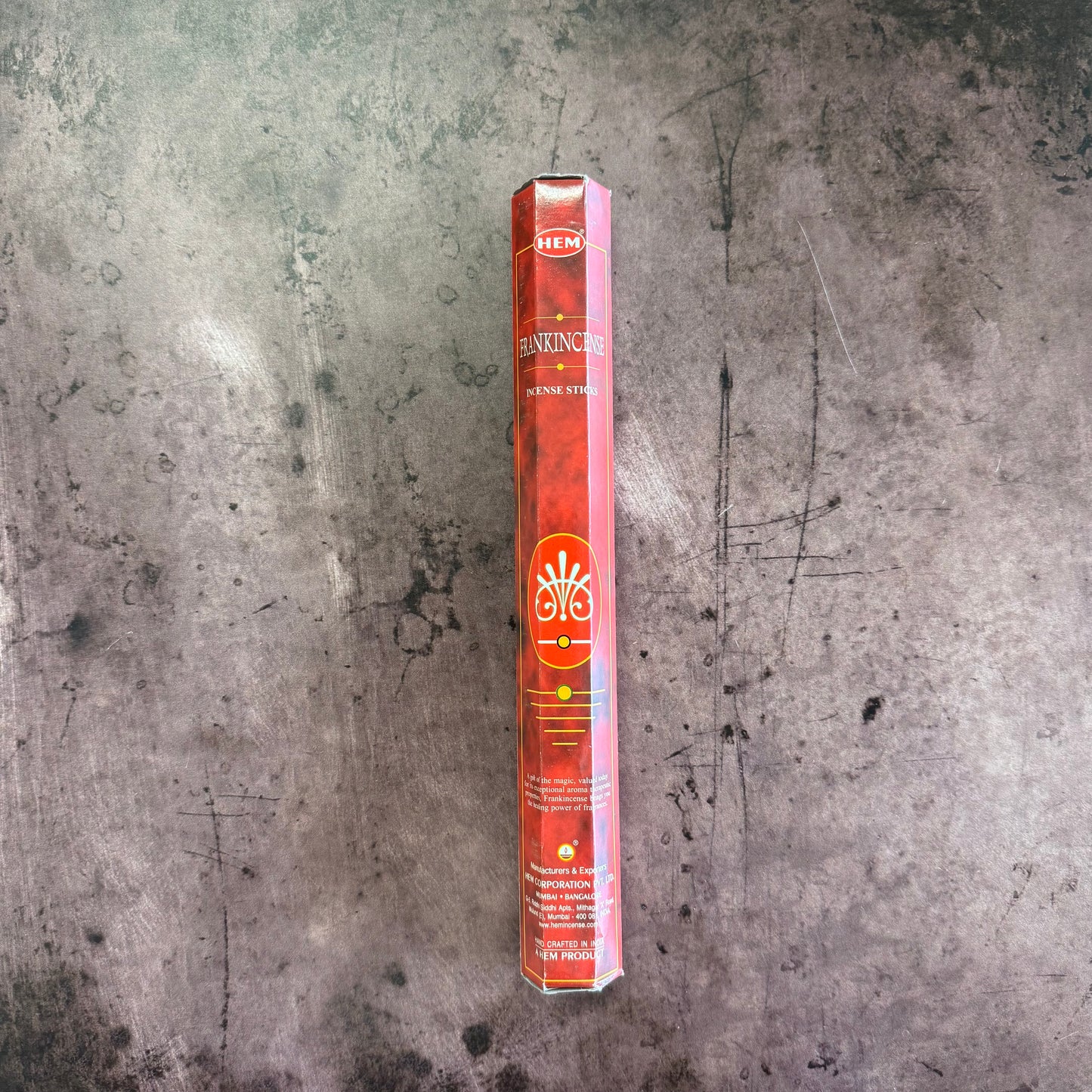 Hankincs incense stick packaging on a textured gray surface