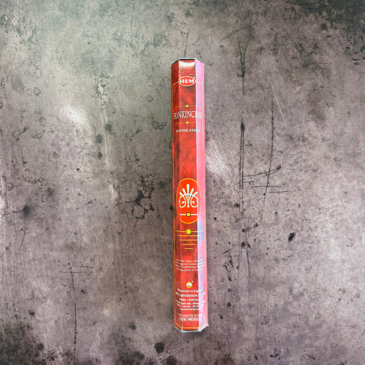 Hankincs incense stick packaging on a textured gray surface