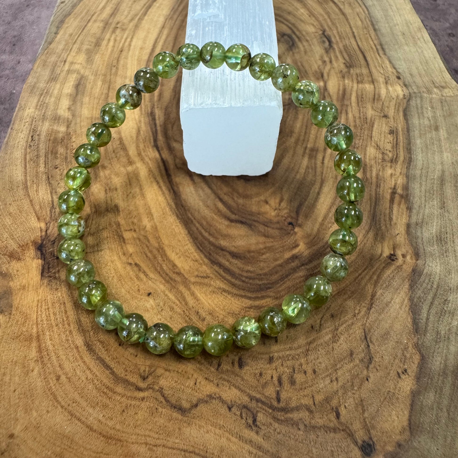 Green beaded bracelet on a wooden surface