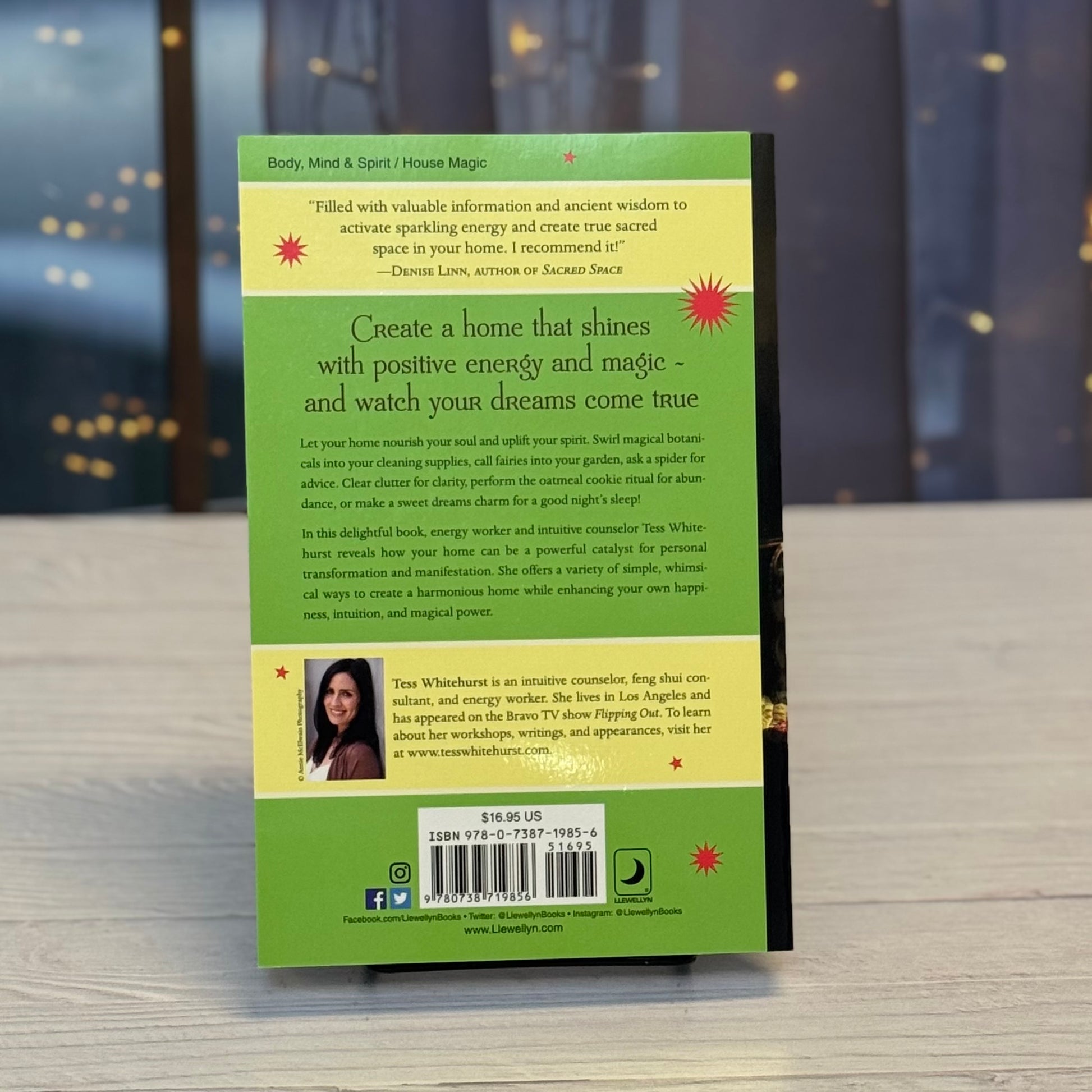 Book cover with green background and text on a wooden surface