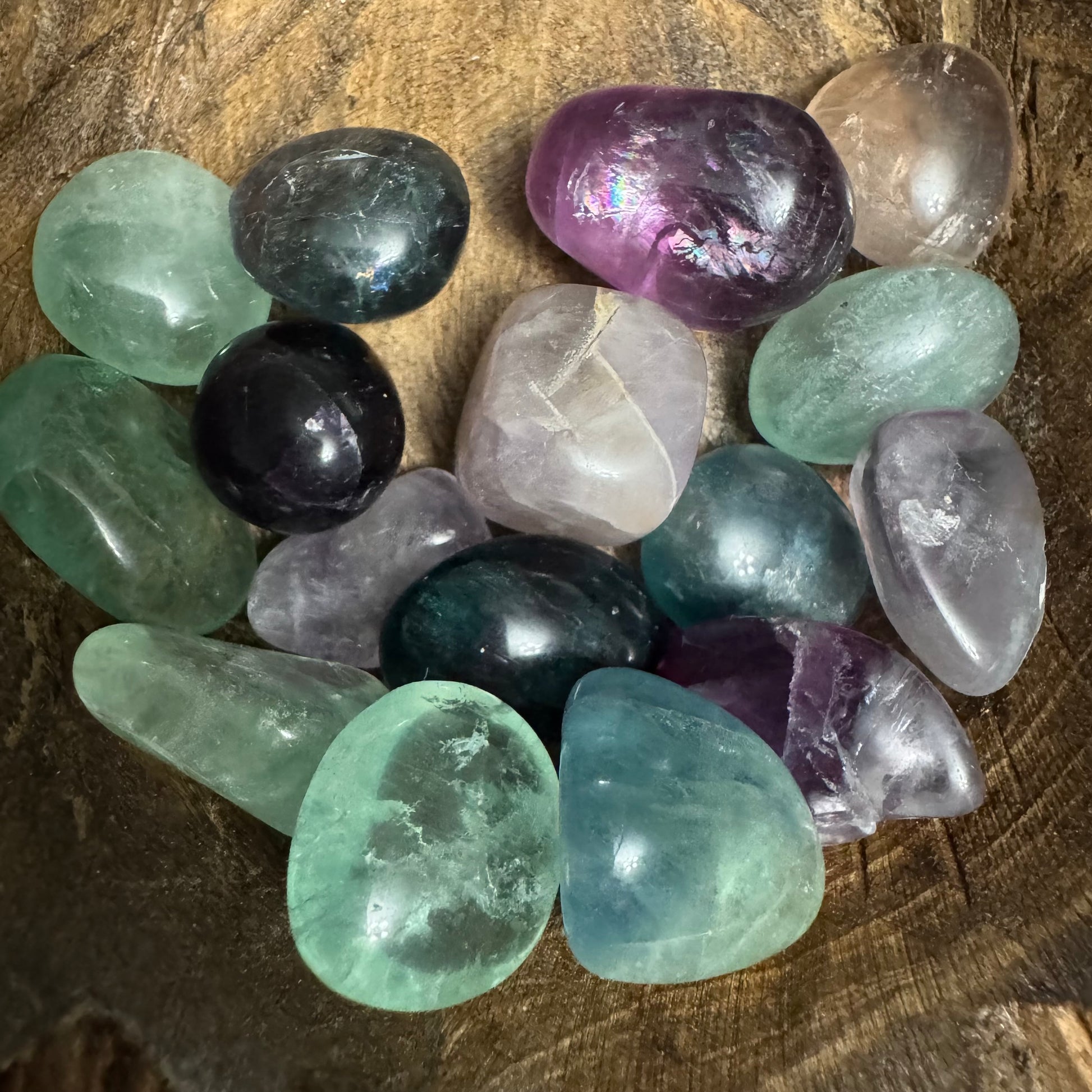 Assorted colorful crystals on a wooden surface