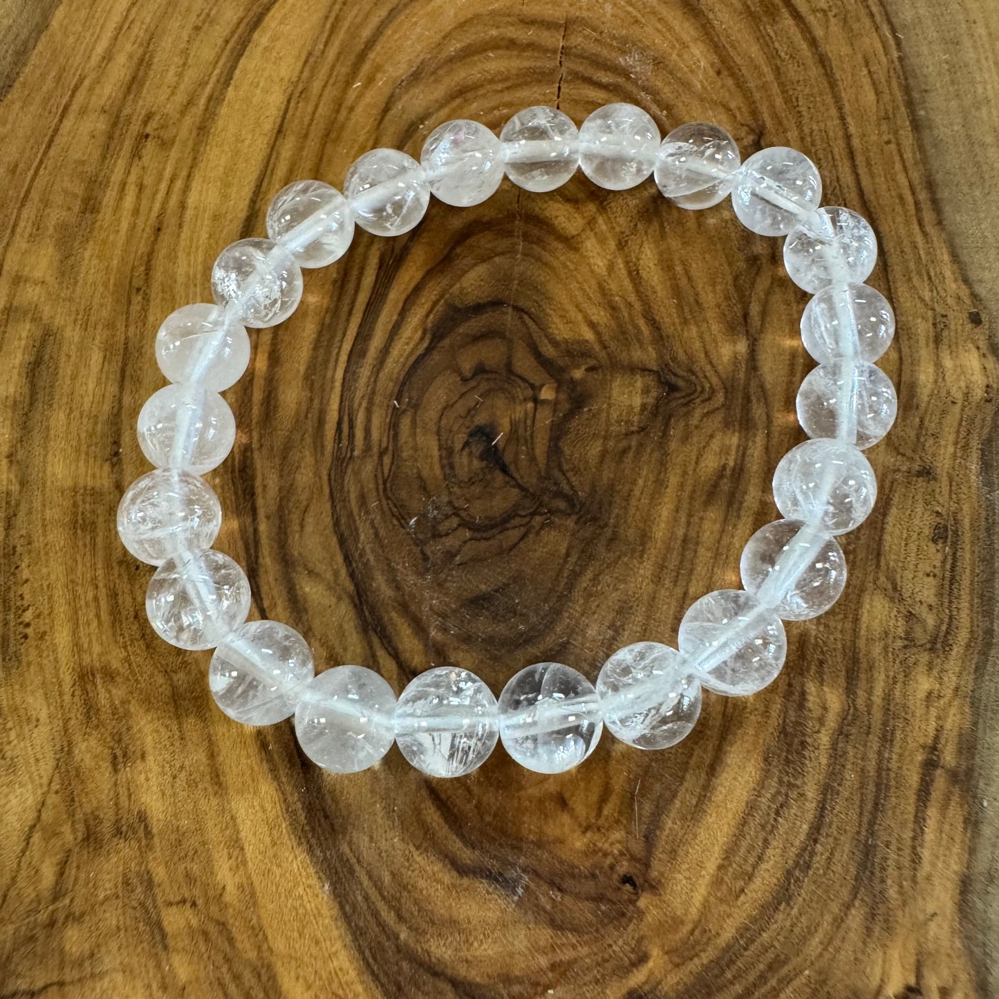 Clear beaded bracelet on a wooden surface