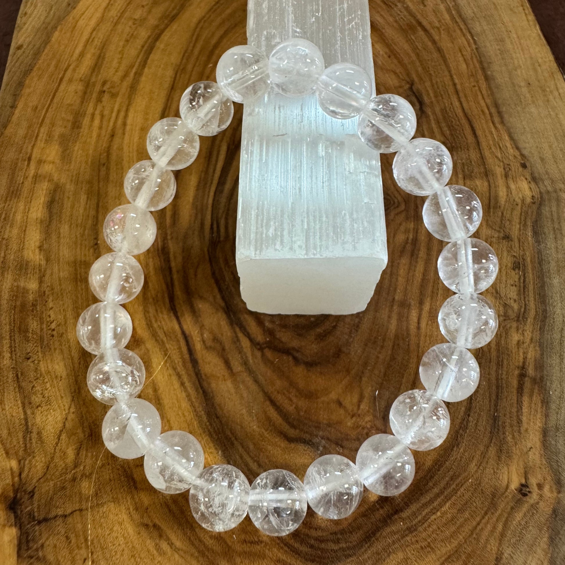 Clear beaded bracelet on a wooden surface