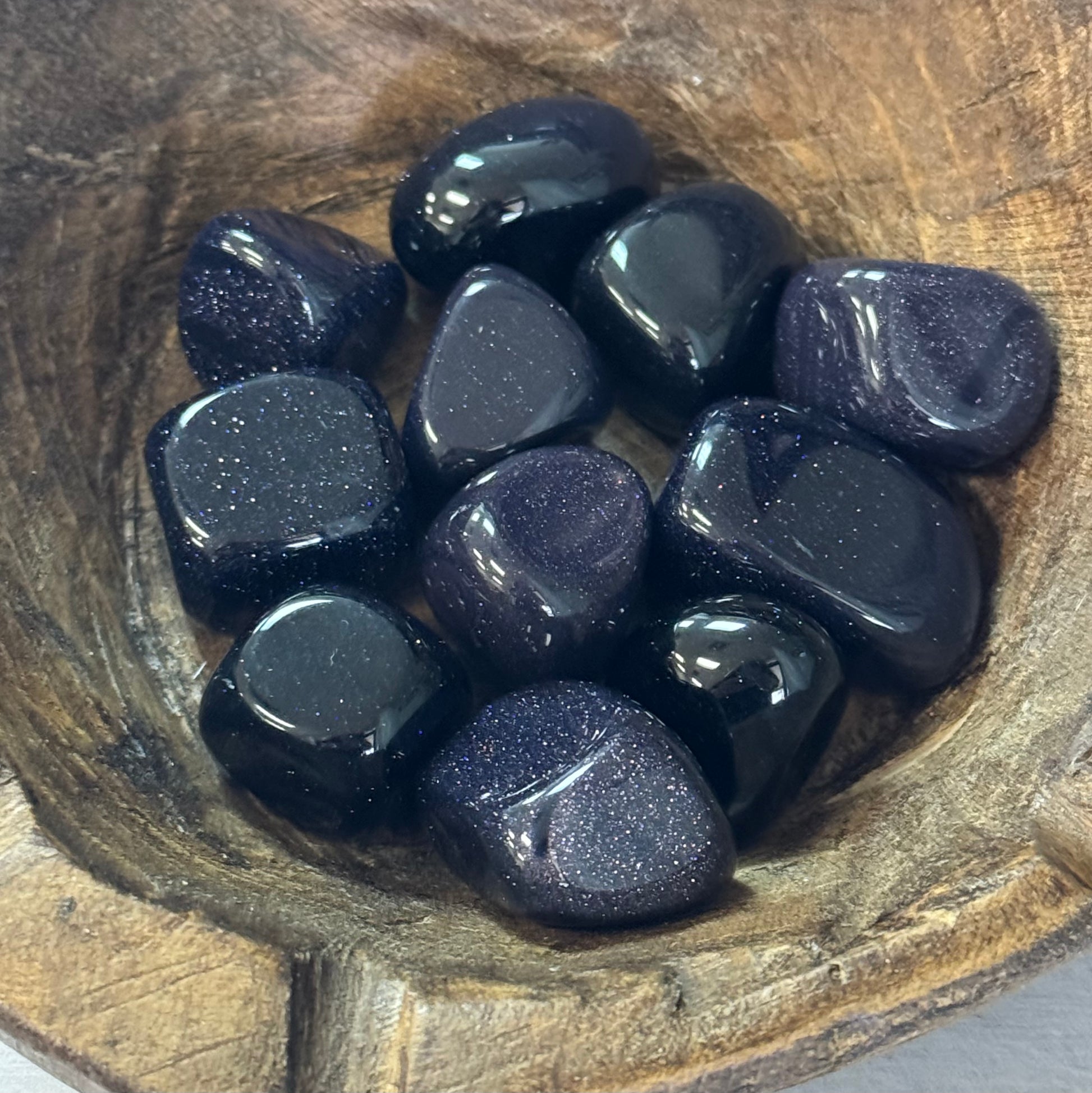Purple stones on a wooden surface