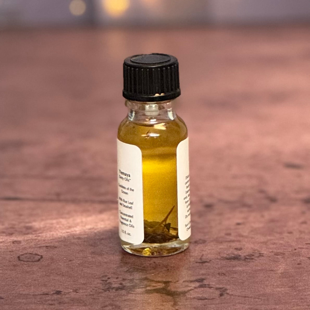 Small glass bottle with a black cap and white label on a wooden surface
