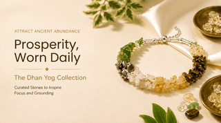 A beaded bracelet from The Dhan Yog Collection displayed on a cream background with decorative leaves and bowls of crystals. The bracelet features a silver-toned clasp and multiple colored stones including green, yellow, white, and dark brown.